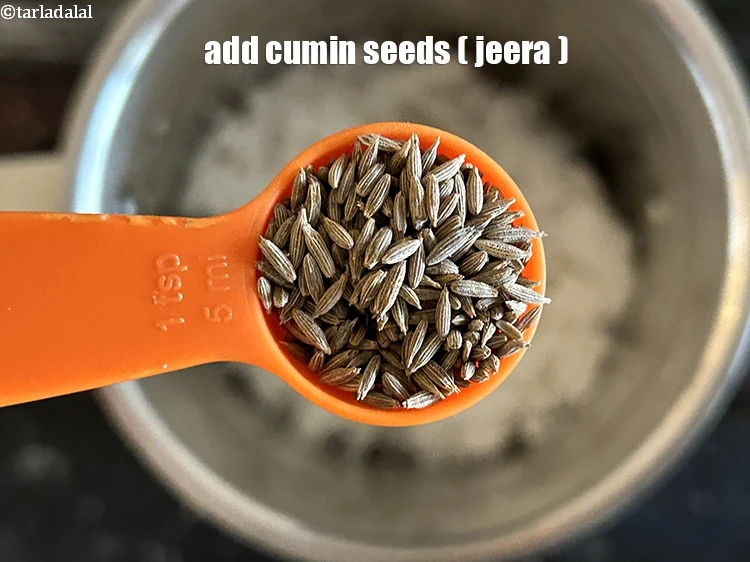 Step 2 – <p><span style="background-color:rgb(255,255,255);color:rgb(0,0,0);">Add 1/2 tsp </span><a href="https://www.tarladalal.com/glossary-cumin-seeds-jeera-zeera-381i"><u>cumin seeds (jeera)</u></a></p>