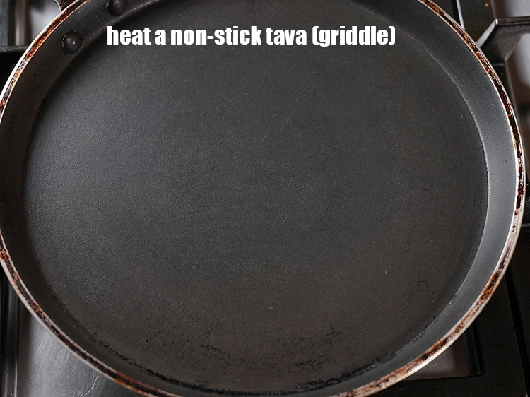Step 16 – <html><head><meta charset="UTF-8"> </head><body><p>Heat a non-stick tava (griddle).</p></body></html>