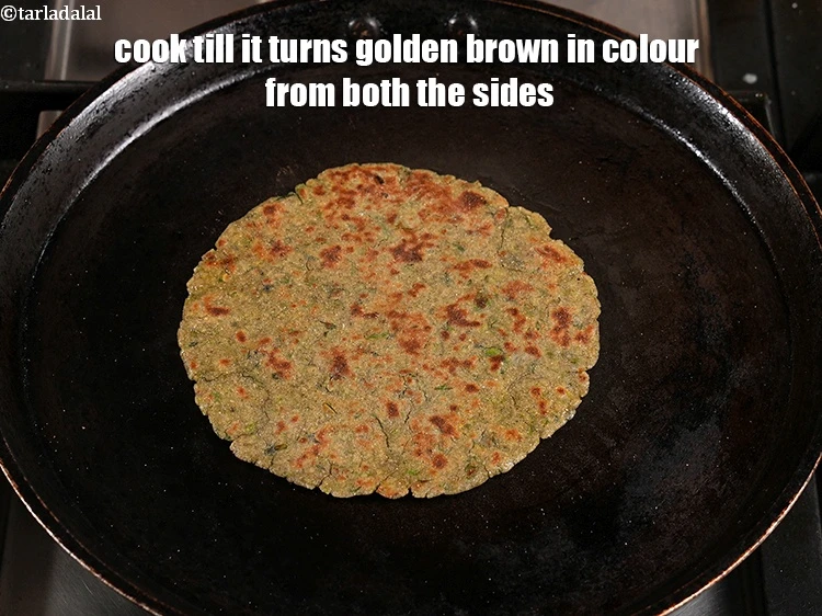 Step 20 – <p>Cook&nbsp;till it turns golden brown in colour from both the sides.&nbsp;Repeat&nbsp;to make 7 more rotis.</p>