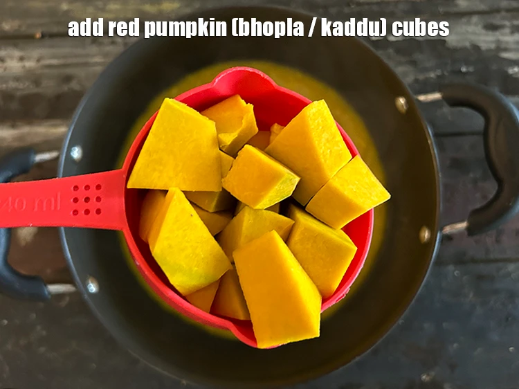 Step 11 – <p>Add <span style="background-color:rgb(255,255,255);color:rgb(0,0,0);">3/4 cup </span><a href="https://www.tarladalal.com/glossary-red-pumpkin-kaddu-lal-bhopla-bhopla-595i#ing_2471"><u>red pumpkin (bhopla / kaddu) cubes</u></a><u>.</u></p>