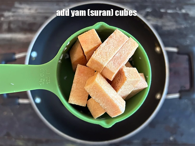 Step 13 – <p>Add <span style="background-color:rgb(255,255,255);color:rgb(0,0,0);">1/2 cup </span><a href="https://www.tarladalal.com/glossary-yam-ratalu-suran-jimikand-485i#ing_2336"><u>yam (suran) cubes</u></a>.</p>