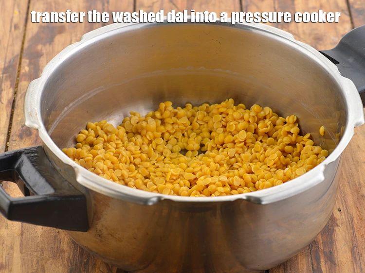 Step 6 – <p><span style="background-color:rgb(255,255,255);color:rgb(0,0,0);">Transfer the washed dal into a pressure cooker.</span></p>