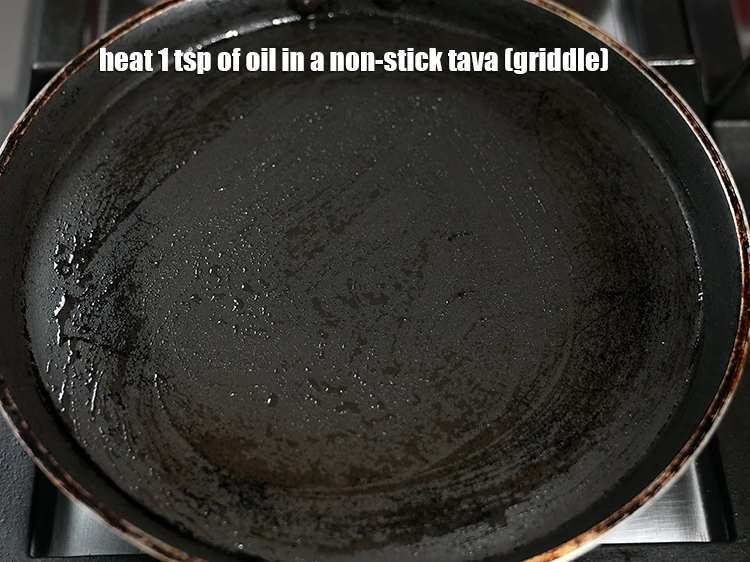 Step 18 – <p><span style="background-color:rgb(255,255,255);color:rgb(0,0,0);">Heat 1 tsp of </span><a href="https://www.tarladalal.com/glossary-oil-671i"><u>oil&nbsp;</u></a><span style="background-color:rgb(255,255,255);color:rgb(0,0,0);"> in a non-stick tava (griddle).</span></p>
