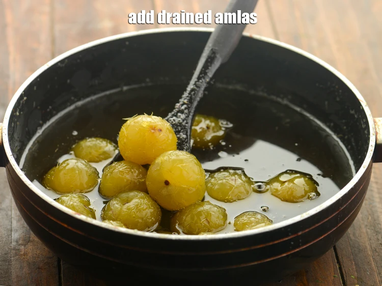 Step 22 – <p><span style="background-color:rgb(255,255,255);color:rgb(0,0,0);">Add the drained </span><a href="https://www.tarladalal.com/glossary-amla-Indian-gooseberry-49i"><u>amla (Indian gooseberries)</u></a></p>