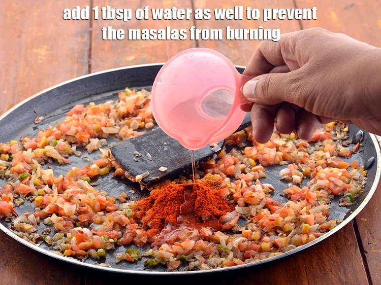 Step 12 – <p>Add 1 tbsp of <strong>water</strong> as well to prevent the masalas from burning.</p>
