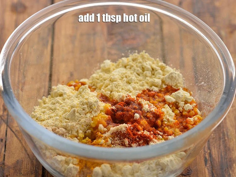 Step 17 – <p>Add <span style="background-color:rgb(255,255,255);color:rgb(0,0,0);">1 tbsp hot </span><a href="https://www.tarladalal.com/glossary-oil-671i"><u>oil</u></a>. This helps in giving the <strong>Paneer Pakora’s</strong> crispy …