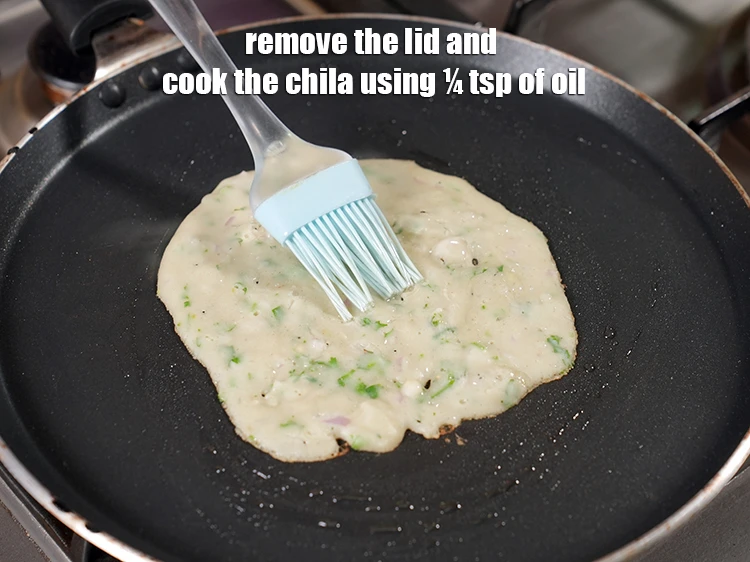 Step 20 – <p><span style="background-color:rgb(255,255,255);color:rgb(0,0,0);">Remove the lid and <strong>cook</strong> the </span><strong>Chilla</strong><span style="background-color:rgb(255,255,255);color:rgb(0,0,0);"> using ¼ tsp of </span><a href="https://www.tarladalal.com/glossary-oil-671i"><u>oil …
