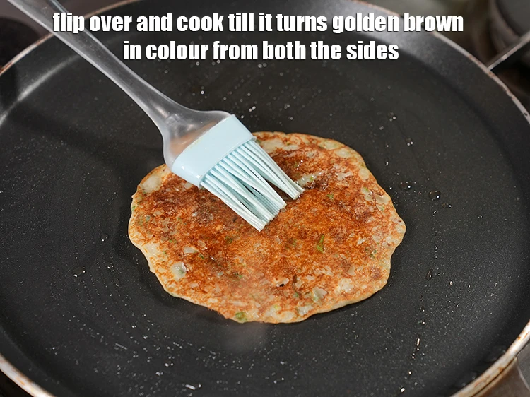 Step 21 – <p>Flip over and cook till it turns golden brown in colour from both the sides.</p>