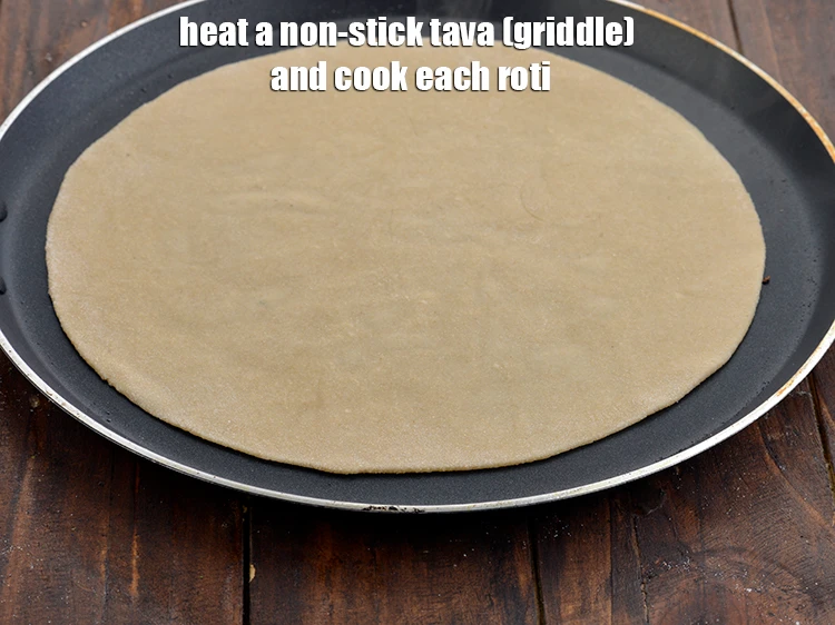Step 11 – <p><span style="background-color:rgb(255,255,255);color:rgb(0,0,0);">Heat a non-stick tava (griddle) on a high flame&nbsp; and place the <strong>roti</strong> on …