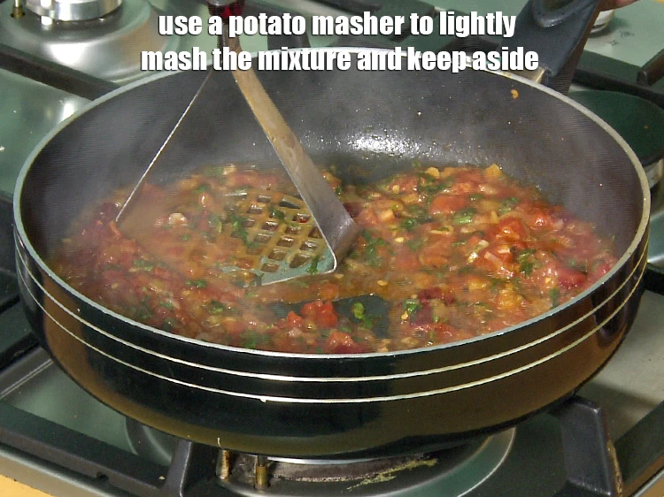 Step 28 – <p><span style="background-color:rgb(255,255,255);color:rgb(0,0,0);">Use a <strong>potato masher</strong> to lightly mash the mixture and keep aside.</span></p>
