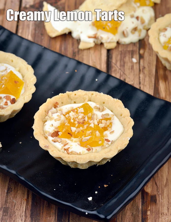 Step 7 – <p><span style="background-color:rgb(255,255,255);color:rgb(0,0,0);">Serve <strong>Creamy Lemon Tarts, Eggless </strong>immediately</span></p>