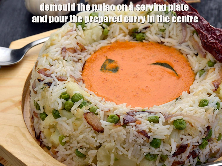Step 10 – <p><span style="background-color:rgb(255,255,255);color:rgb(0,0,0);"><strong>Demould the pulao on a serving plate</strong> and pour the <strong>prepared curry</strong> in the …