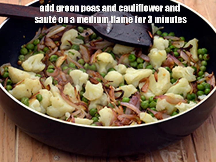 Step 6 – <p><span style="background-color:rgb(255,255,255);color:rgb(0,0,0);">Add the 1 cup </span><a href="https://www.tarladalal.com/glossary-green-peas-matar-hare-matar-vatana-180i#ing_2431"><u>boiled green peas</u></a><span style="background-color:rgb(255,255,255);color:rgb(0,0,0);"> and 1 cup </span><a href="https://www.tarladalal.com/glossary-cauliflower-phool-gobi-phool-gobhi-174i#ing_2598"><u>boiled …