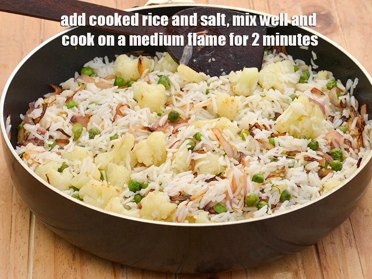 Step 7 – <p><span style="background-color:rgb(255,255,255);color:rgb(0,0,0);">Add the 2 1/2 cups </span><a href="https://www.tarladalal.com/cooked-rice-32639r"><strong><u>cooked rice</u></strong></a><span style="background-color:rgb(255,255,255);color:rgb(0,0,0);"> (chawal) and </span><a href="https://www.tarladalal.com/glossary-salt-namak-table-salt-418i"><u>salt </u></a><span …