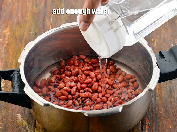 Step 20 – <p>Add enough <strong>water</strong> to cover the rajma.</p>
