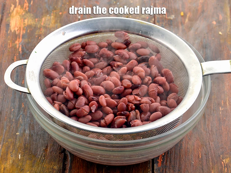 Step 22 – <p>Drain the cooked <strong>rajma</strong> with the help of a strainer.</p>