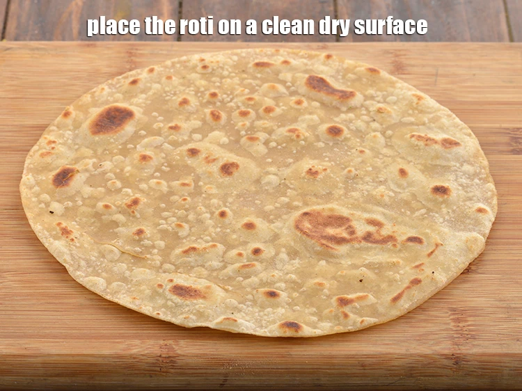 Step 46 – <p>Place the <strong>roti </strong>on a clean dry surface.</p>