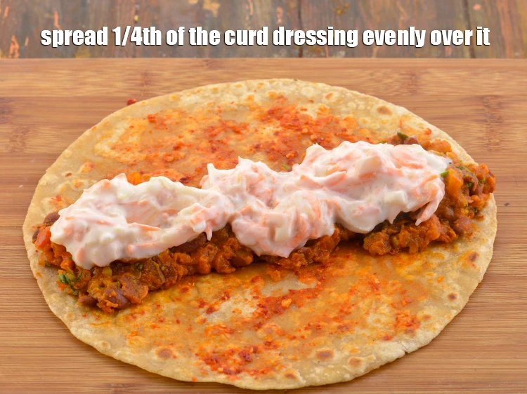 Step 49 – <p>Spread 1/4th of the <strong>curd dressing</strong> evenly over it.</p>