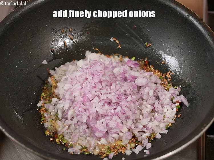 Step 25 – <p>Add ¾ cup finely <a href="https://www.tarladalal.com/glossary-chopped-onions-722i">chopped onions</a>.</p>