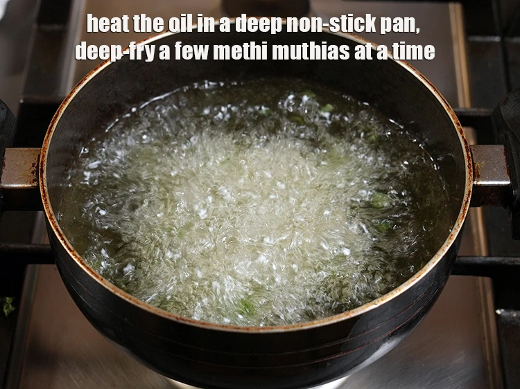 Step 19 – <p><span style="background-color:rgb(255,255,255);color:rgb(0,0,0);">Heat the </span><a href="https://www.tarladalal.com/glossary-oil-671i"><u>oil</u></a><span style="background-color:rgb(255,255,255);color:rgb(0,0,0);"> in a deep non-stick pan and drop few <strong>muthias</strong> …