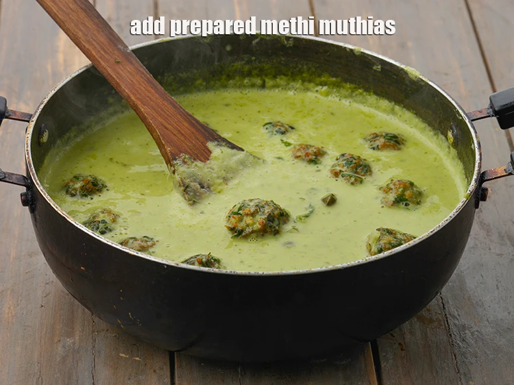 Step 28 – <p><span style="background-color:rgb(255,255,255);color:rgb(0,0,0);"><strong>Just before serving</strong>, re-heat the <strong>hara chana coconut curry</strong>, add the <strong>prepared methi muthias</strong>.</span></p>