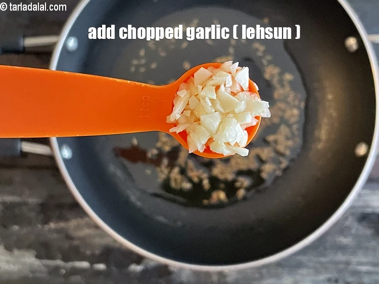 Step 22 – <html><head></head><body><p>Add&nbsp;2 tsp&nbsp;finely&nbsp;<a href="glossary-chopped-garlic-790i">chopped garlic (lehsun)</a>.</p></body></html>