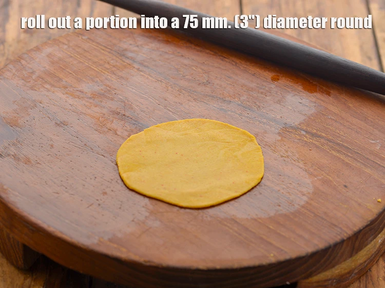 Step 14 – <p>Roll out a portion into a 75 mm. (3") diameter round. If the dough is …