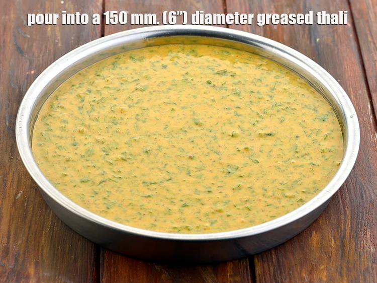Step 6 – <p><span style="background-color:rgb(255,255,255);color:rgb(0,0,0);">Pour the <strong>mixture</strong> to the greased thali.</span></p>