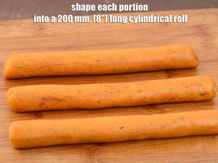 Step 13 – <p><span style="background-color:rgb(255,255,255);color:rgb(0,0,0);">Shape each portion into a 200 mm. (8") <strong>long cylindrical roll</strong>.</span></p>