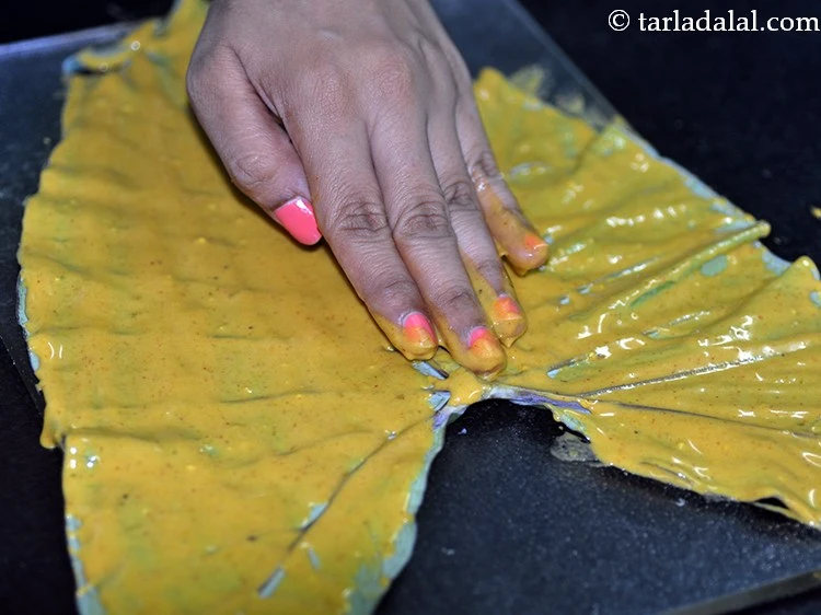 Step 17 – <p>Spread a little beasn mixture evenly on the colocassia leaf using your fingers. Spread gently …