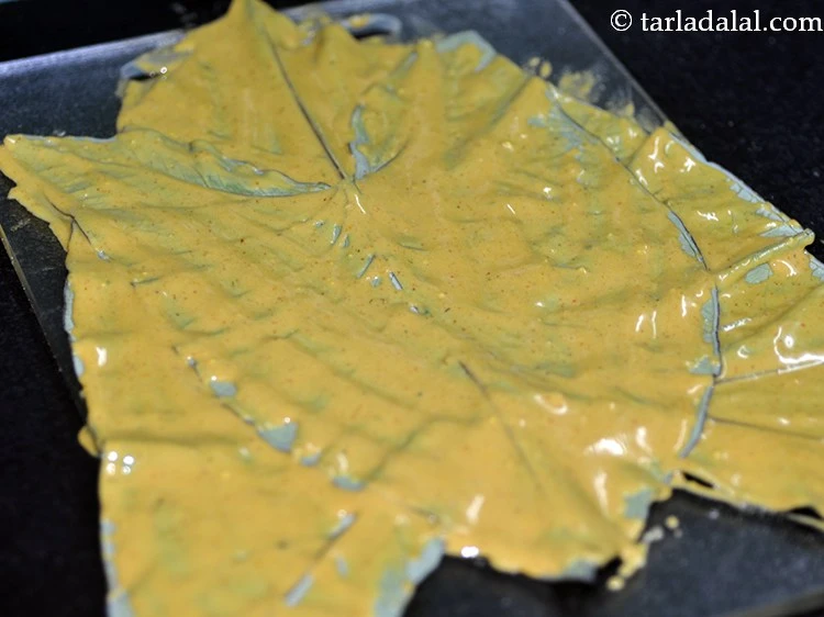 Step 19 – <p>Again spread a little besan mixture evenly over the colocassia leaf. You can make 2 …