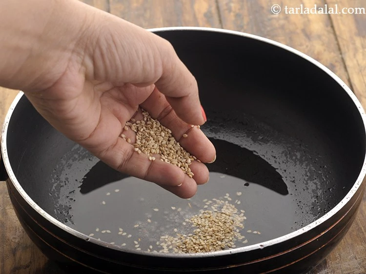 Step 32 – <p>When the seeds crackle, add the sesame seeds.</p>