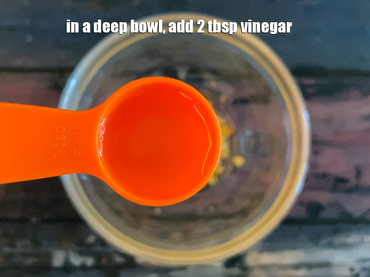 Step 1 – <p>To make the<strong> Salad</strong> <strong>Dressing</strong>, <span style="background-color:rgb(255,255,255);color:rgb(0,0,0);">in a deep bowl, add 2 tbsp </span><a href="https://www.tarladalal.com/glossary-vinegar-sirka-cooking-vinegar-341i"><u>vinegar</u></a><u>.</u></p>