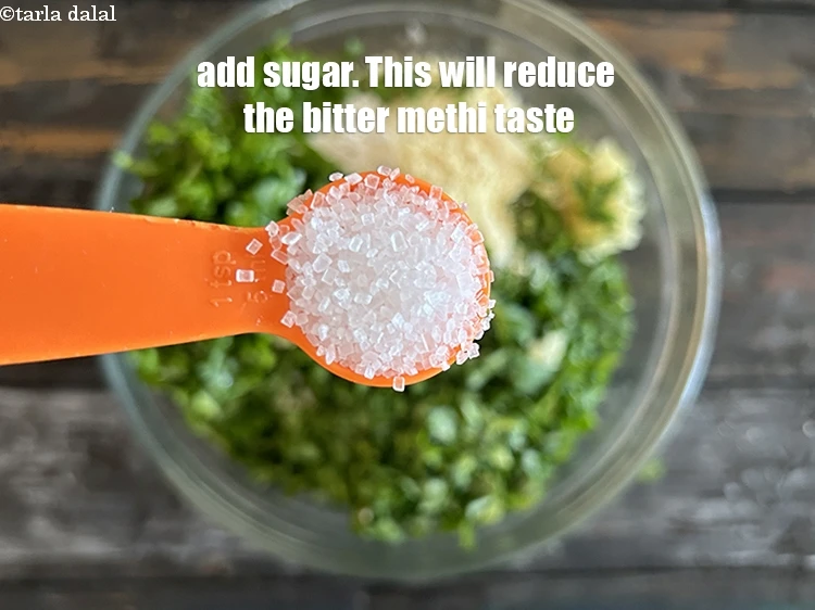 Step 10 – <p><span style="background-color:rgb(255,255,255);color:rgb(0,0,0);">Add&nbsp;3 tsp </span><a href="https://www.tarladalal.com/glossary-sugar-chini-shakkar-278i"><u>sugar</u></a><span style="background-color:rgb(255,255,255);color:rgb(0,0,0);">. This will reduce the bitter taste of methi.</span></p>