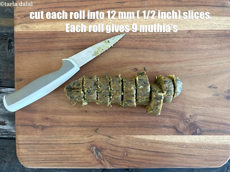 Step 24 – <p>Cut each steamed roll into 12 mm. (½”) slices. Each roll gives 9 muthia's.&nbsp;</p>