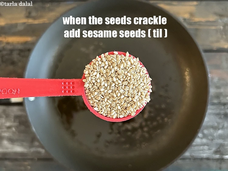 Step 28 – <html><head></head><body><p>When the seeds crackle, add 1 tbsp&nbsp;<a href="glossary-sesame-seeds-til-gingelly-seeds-612i">sesame seeds (til)</a>.</p></body></html>