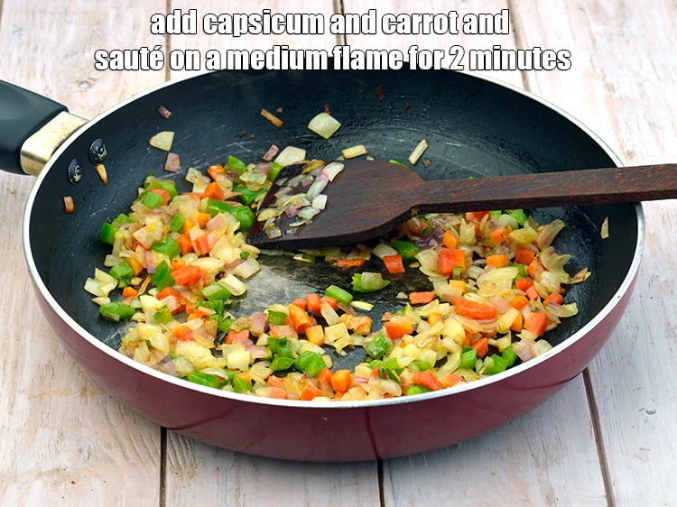 Step 4 – <p><span style="background-color:rgb(255,255,255);color:rgb(0,0,0);">Add the 2 tbsp </span><a href="https://www.tarladalal.com/glossary-capsicum-shimla-mirch-bell-pepper-163i#ing_2311"><u>chopped capsicum</u></a><span style="background-color:rgb(255,255,255);color:rgb(0,0,0);"> and 2 tbsp </span><a href="https://www.tarladalal.com/glossary-carrot-gajar-gajjar-253i#ing_2376"><u>chopped carrot</u></a><span …