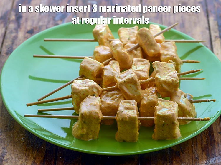 Step 8 – <p><span style="background-color:rgb(255,255,255);color:rgb(0,0,0);">In a skewer insert 3 marinated paneer pieces at regular intervals.</span></p>