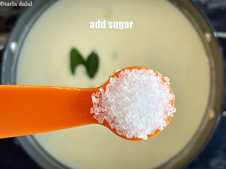 Step 20 – <p><span style="background-color:rgb(255,255,255);color:rgb(0,0,0);">Add 2&nbsp;tsp&nbsp;</span><a href="https://www.tarladalal.com/glossary-sugar-chini-shakkar-278i"><u>sugar</u></a><span style="background-color:rgb(255,255,255);color:rgb(0,0,0);">&nbsp;(approx.). NOTE. If curds are sour, then add more sugar.</span></p>