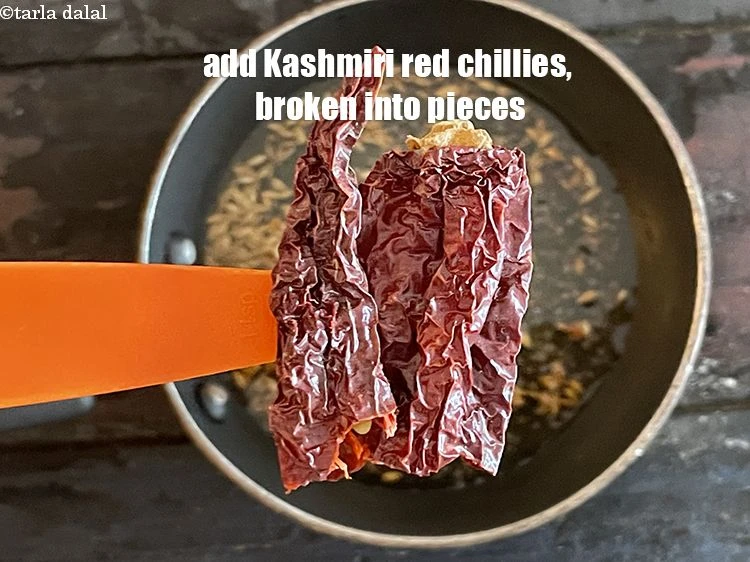 Step 29 – <p>Add 1 <a href="https://www.tarladalal.com/glossary-whole-dry-kashmiri-red-chillies-kashmiri-mirch-kashmiri-lal-mirch-332i"><u>whole dry Kashmiri red chilli </u></a>, broken into pieces.</p>