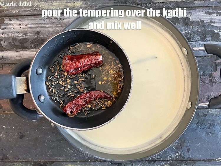 Step 31 – <p>Add the <strong>tempering</strong> to the <strong>kadhi</strong>.</p>