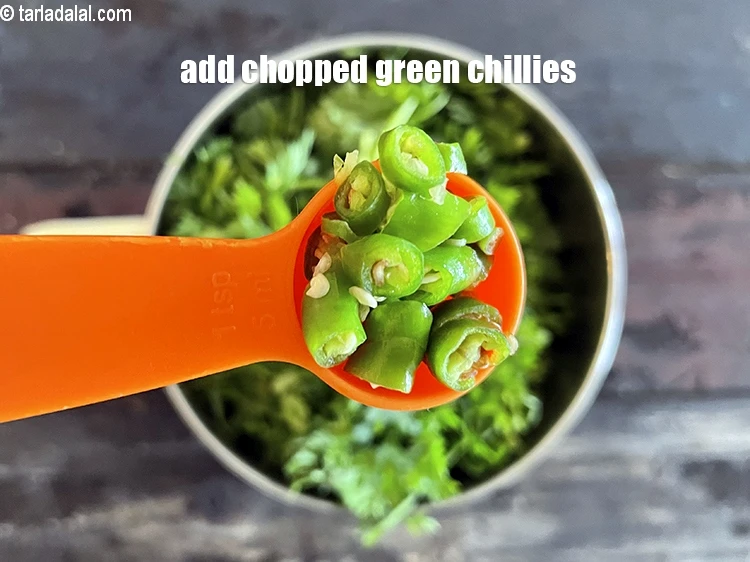 Step 2 – <p><span style="background-color:rgb(255,255,255);color:rgb(0,0,0);">Add&nbsp;5&nbsp;</span><a href="https://www.tarladalal.com/glossary-green-chillies-hari-mirch-331i"><u>green chillies</u></a><span style="background-color:rgb(255,255,255);color:rgb(0,0,0);">&nbsp;, roughly chopped.</span></p>