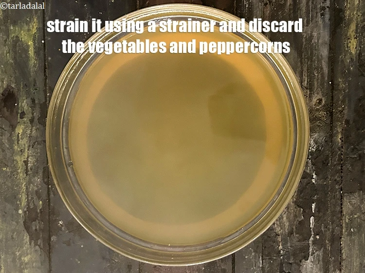 Step 12 – <p>Strain it using a strainer. Preserve the Thai vegetable stock with lemon grass and discard …