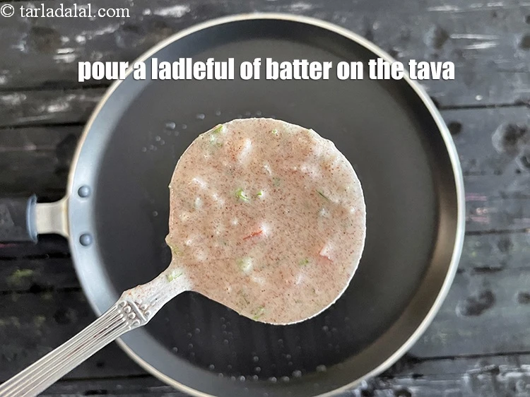 Step 14 – <html><head><meta charset="UTF-8"> </head><body><p>Pour a ladleful of the batter on tava (griddle).</p></body></html>