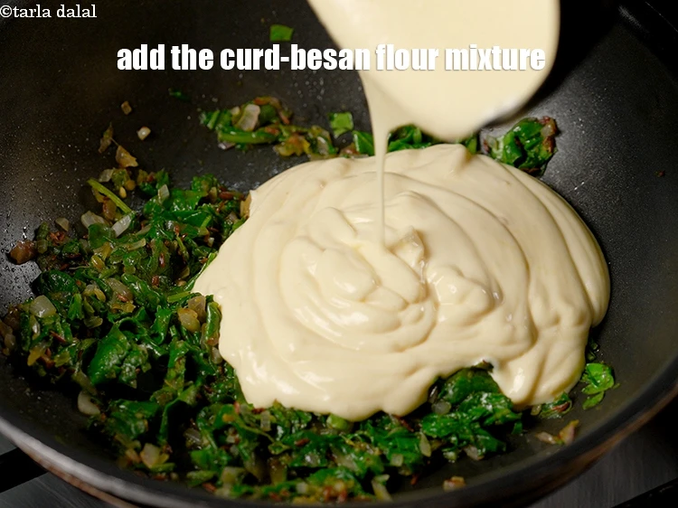 Step 12 – <p>Lower the flame and add the curd-besan flour mixture.</p>