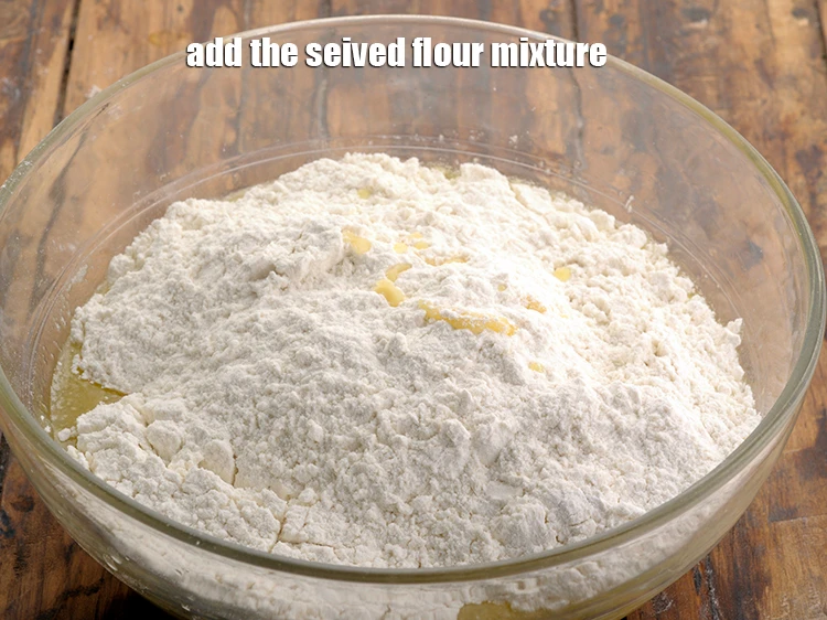 Step 11 – <p><span style="background-color:rgb(255,255,255);color:rgb(0,0,0);">Add the <strong>seived flour </strong>mixture.</span></p>
