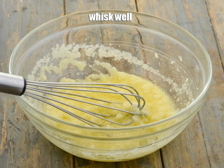 Step 7 – <p>Add 3 tbsp <a href="https://www.tarladalal.com/glossary-oil-671i"><u>oil</u></a> <span style="background-color:rgb(255,255,255);color:rgb(0,0,0);">and whisk well.</span></p>