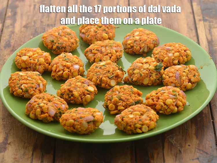 Step 22 – <p>Flatten all the 17 portions of <strong>dal vada</strong> and place them on a plate or …