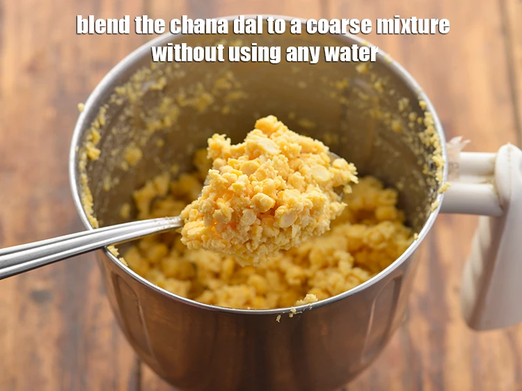 Step 27 – <p><strong>Blend </strong>the <strong>chana dal </strong>to a coarse mixture <strong>without using any water</strong>. If required, once …