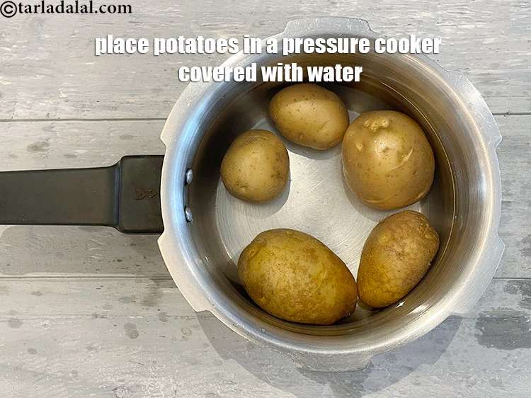 Step 16 – <p>Place potatoes in a flat dish in a pressure cooker covered with water.</p>